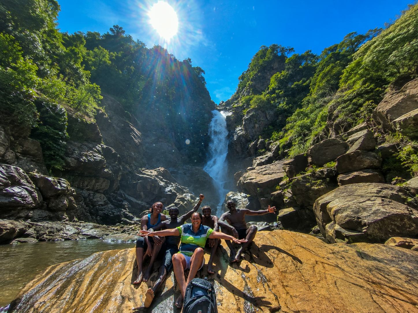Guests celebrating at the base of a waterfall on the Nguruman Escarpment