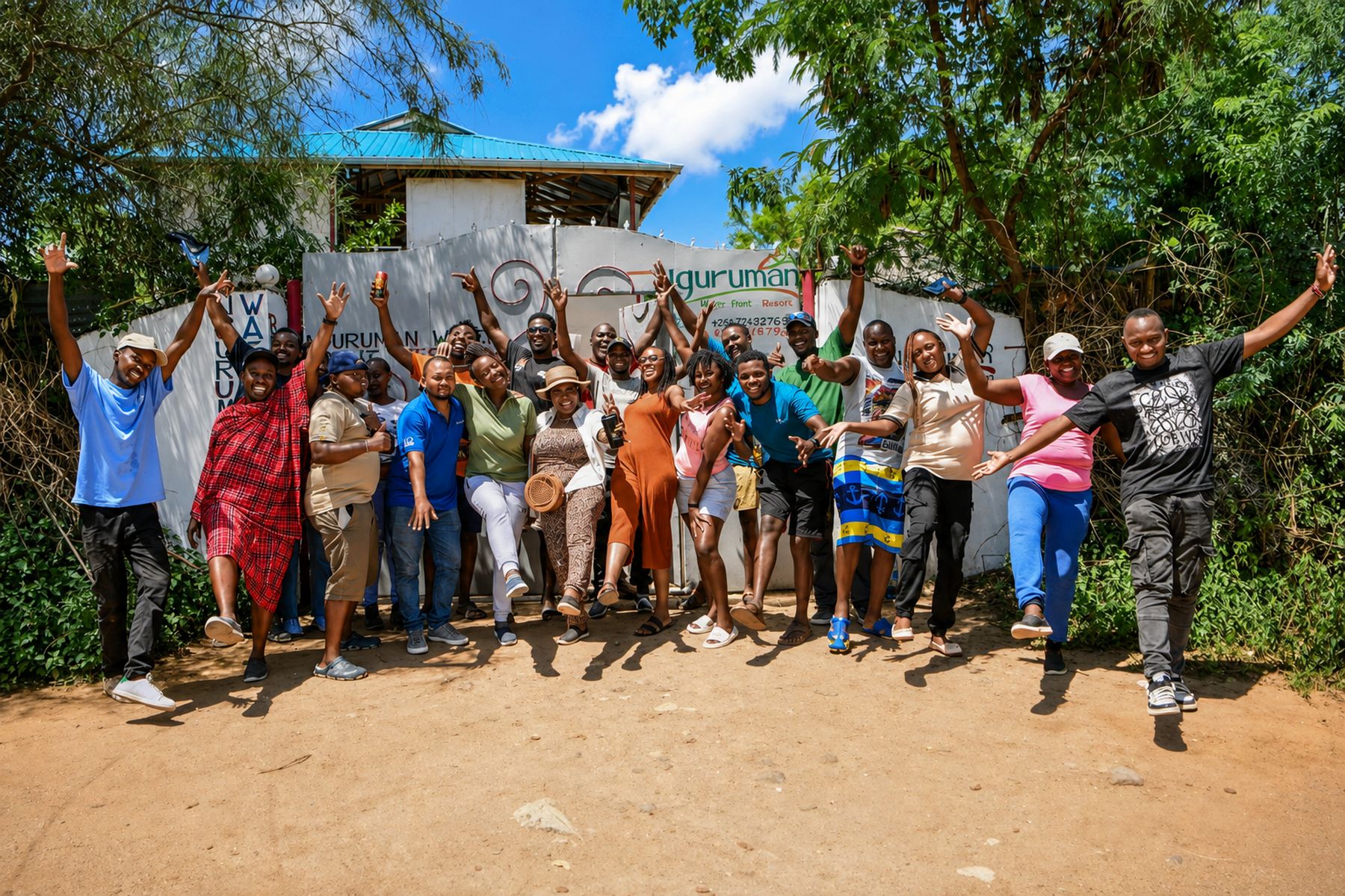 A large group celebrating together outside the Nguruman Waterfront Resort gate